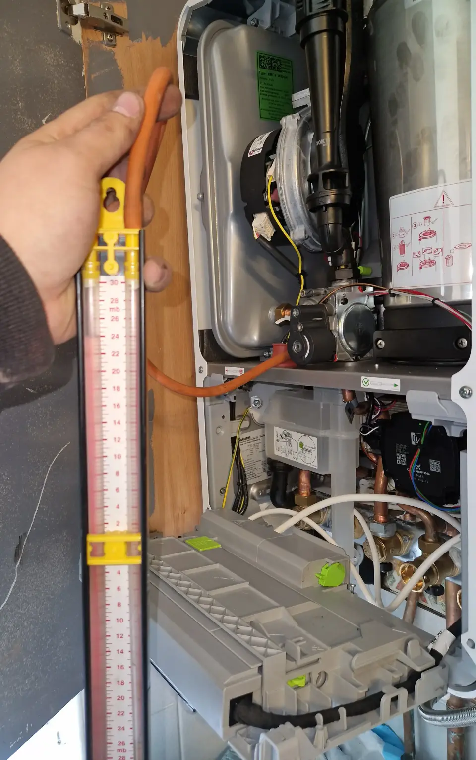 Gas Safe registered engineer diagnosing a boiler fault