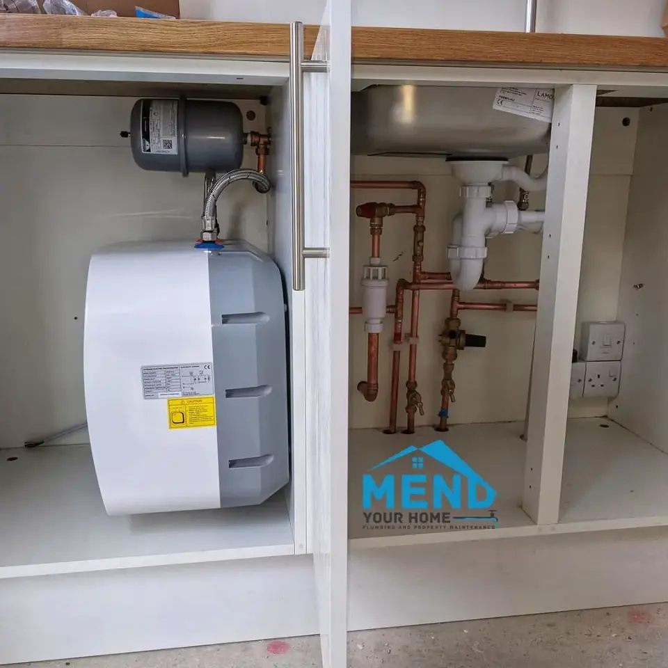 Plumber tracing a concealed leak in pipework